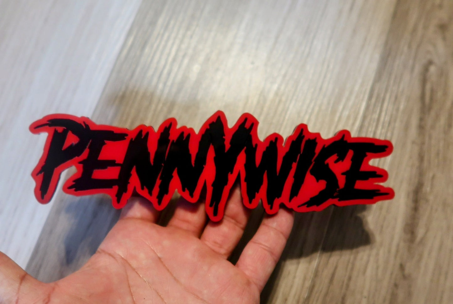 Pennywise car badge. Includes 1.