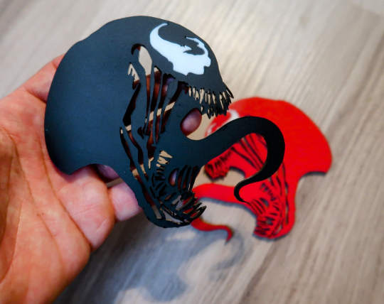 Inspired Carnage and Venom badges. Includes 2.
