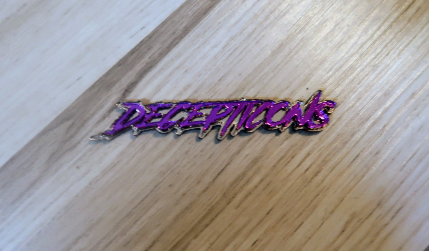 Decepticons text badge. Includes 1.