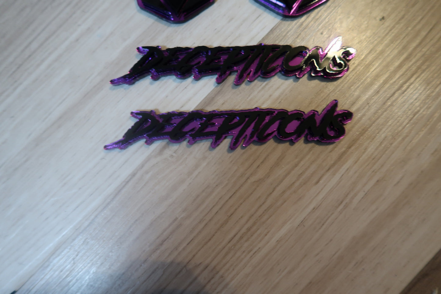 Decepticons text badge. Includes 1.