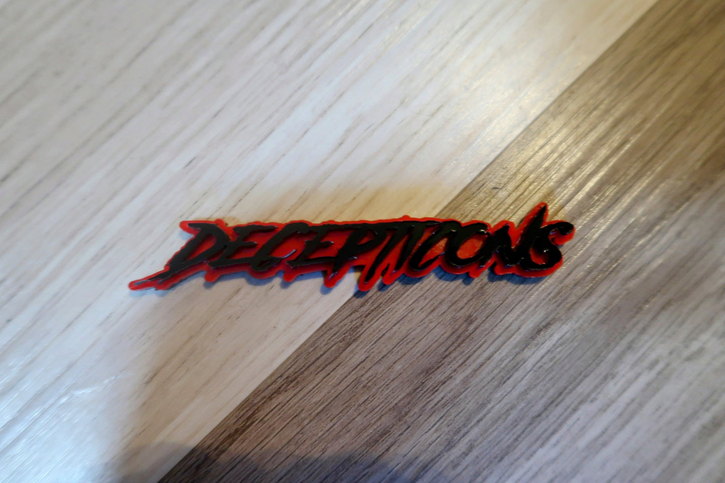 Decepticons text badge. Includes 1.