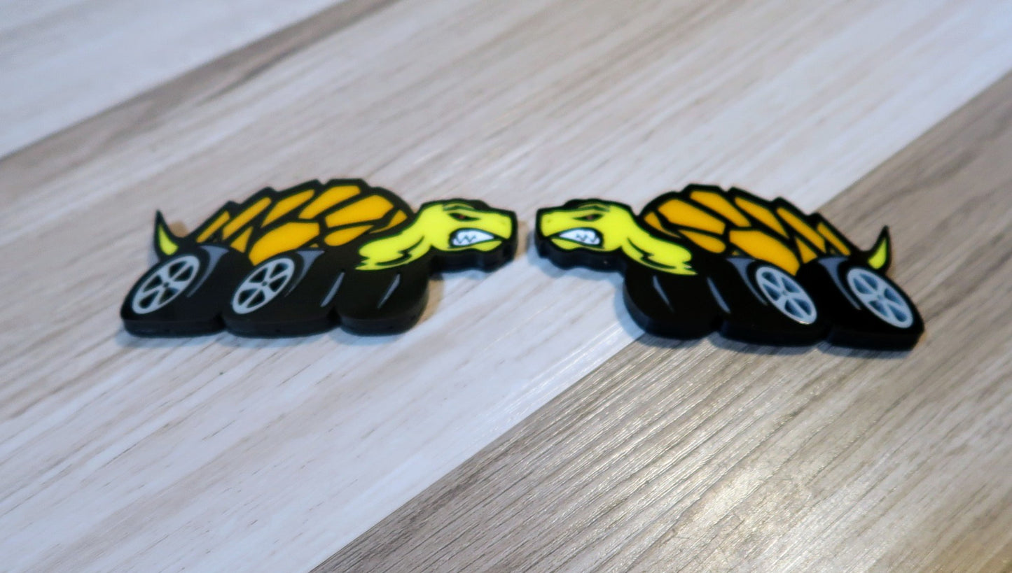 Racing Tortoise badges. Includes 2.