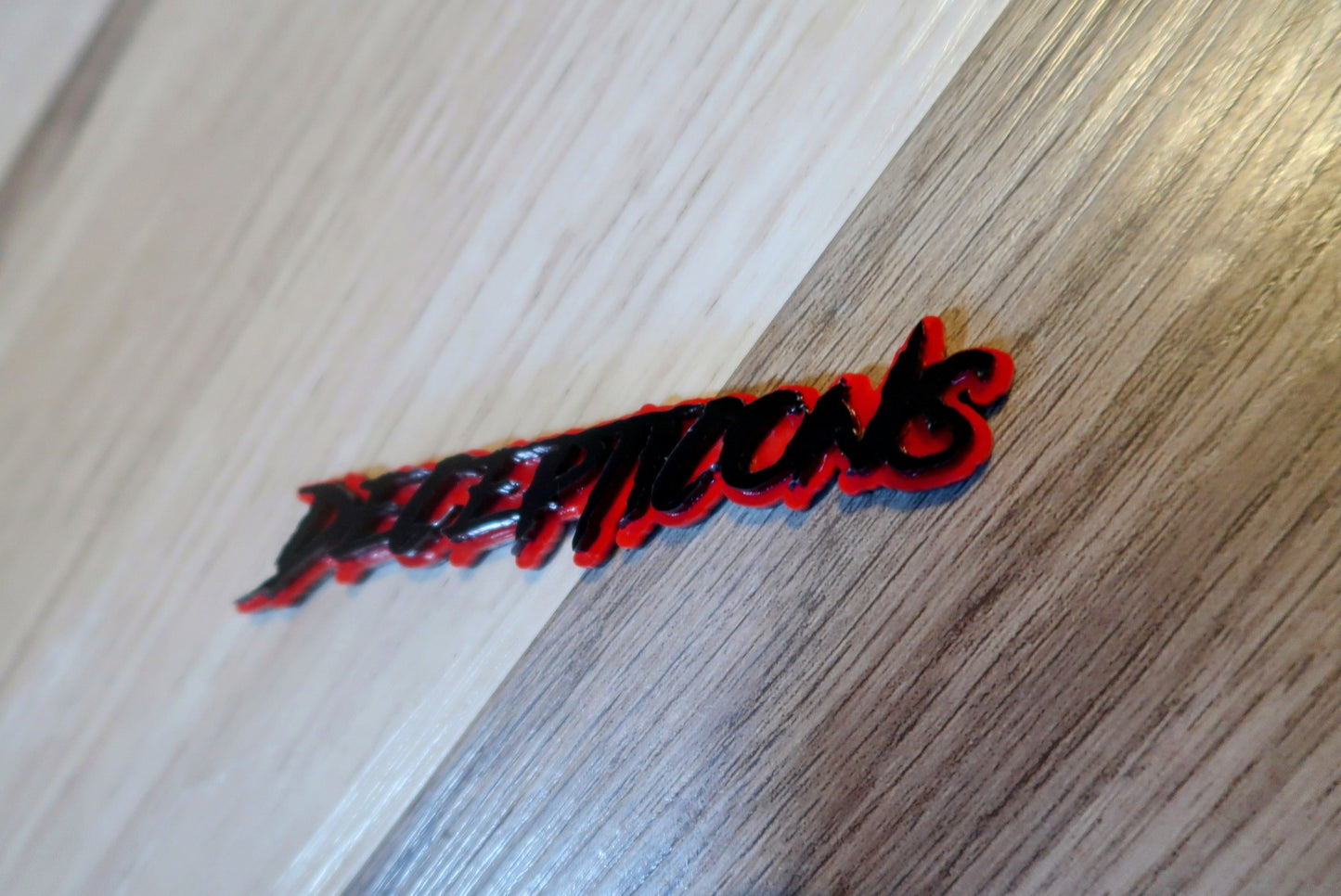 Decepticons text badge. Includes 1.