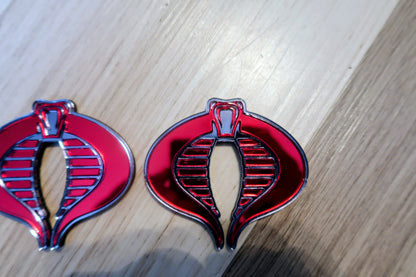G.I. Joe Cobra badges. Includes 2