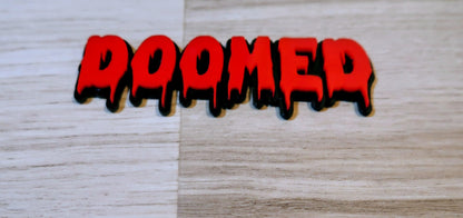 DOOMED Badge. Includes 1