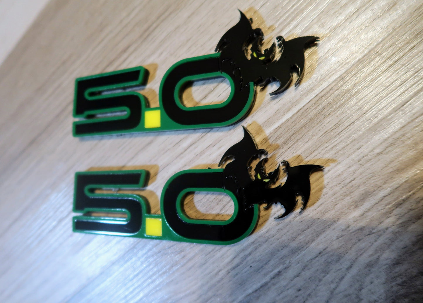 5.0 Bat badges. Includes 2.