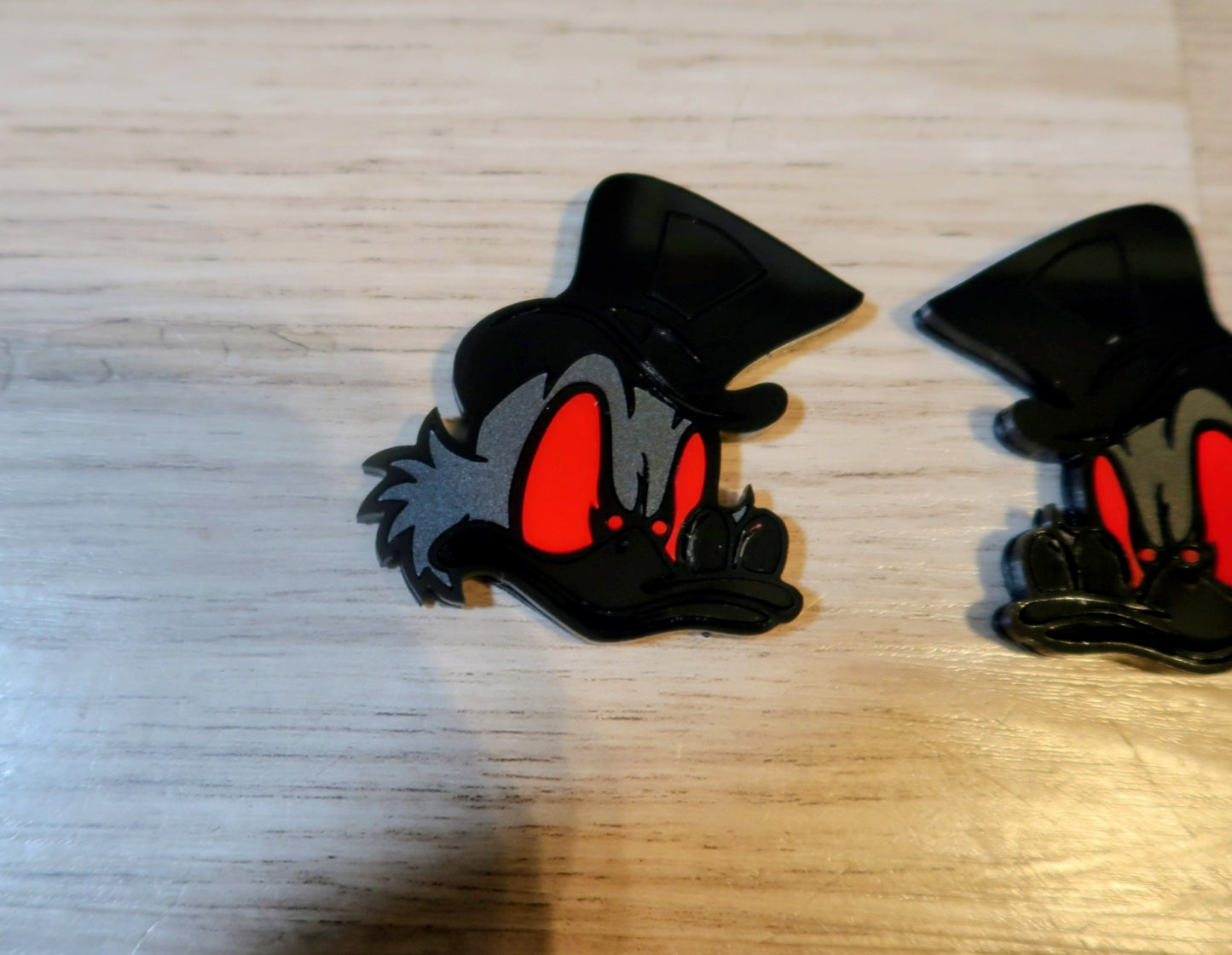 Evil Scrooge fender badges. Includes 2