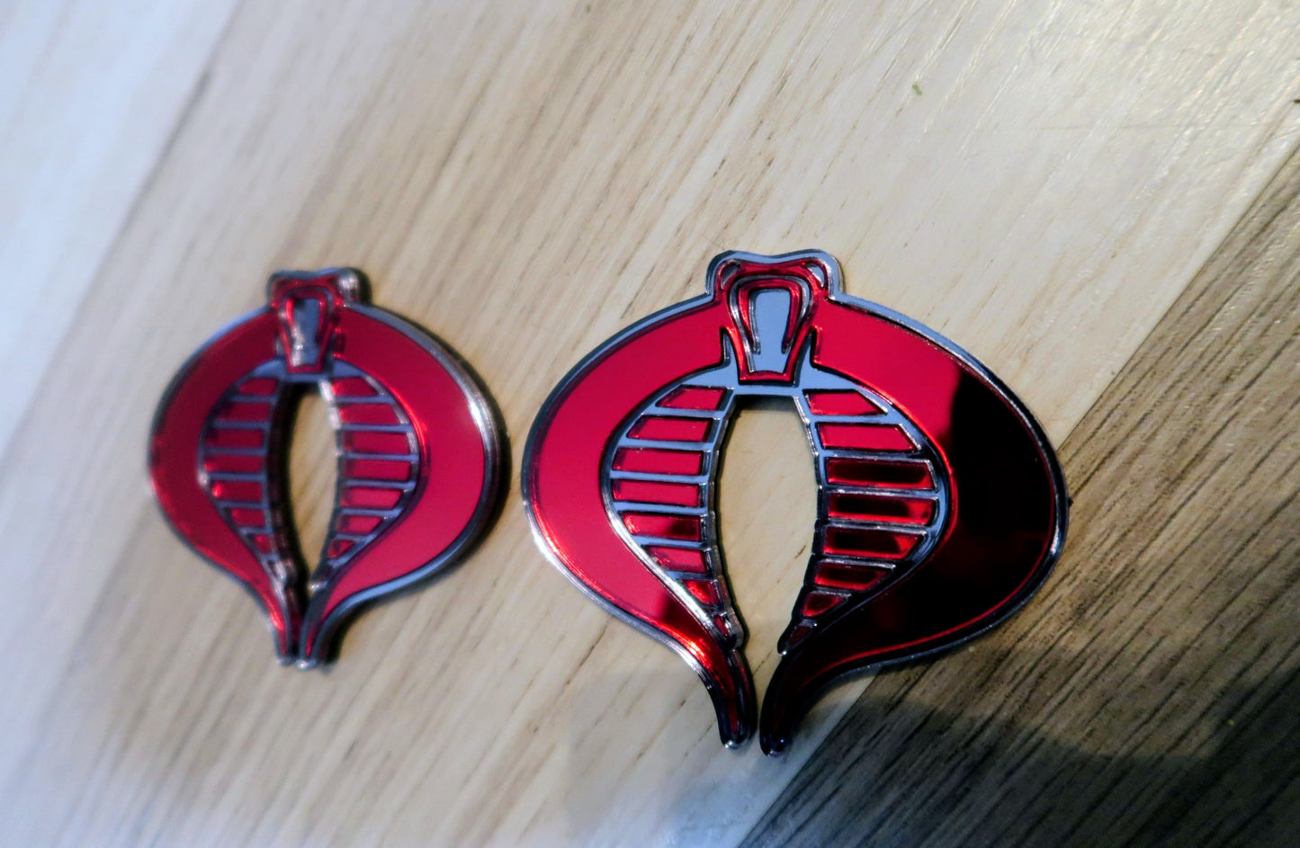 G.I. Joe Cobra badges. Includes 2