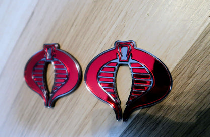 G.I. Joe Cobra badges. Includes 2
